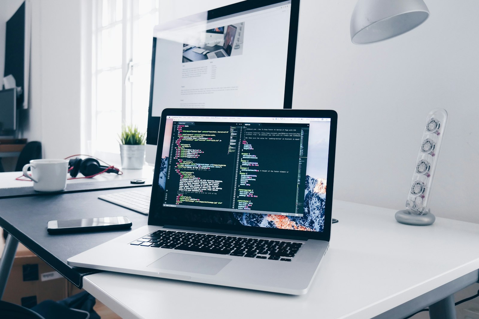 Developer workspace with code on a laptop