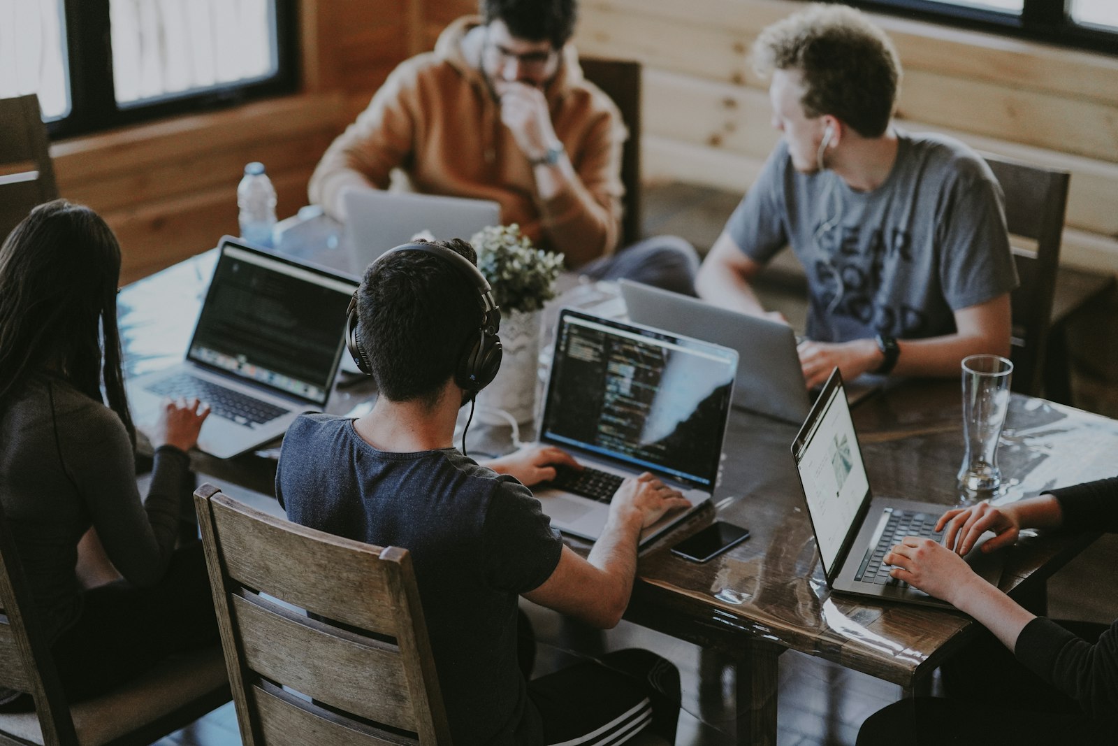 Product team collaborating around laptops